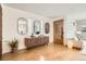 Bright entryway featuring wood floors, a console table, and decorative mirrors at 1717 Irving St, Denver, CO 80204