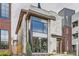 Exterior view of a light stone home with a large window, wooden accents, and landscaping at 1717 Irving St, Denver, CO 80204