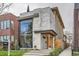 Modern home featuring a light stone facade, a large black-framed window and professional landscaping at 1717 Irving St, Denver, CO 80204