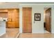 Hallway with hardwood floors and an elevator, next to a kitchen area with modern cabinets and countertops at 1717 Irving St, Denver, CO 80204