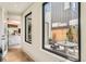 Hallway with a view to the patio with seating and modern design, and a glimpse of the modern kitchen at 1717 Irving St, Denver, CO 80204