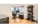 Home office features a sleek glass desk, comfortable chair, and built-in shelves for organized storage and display at 1717 Irving St, Denver, CO 80204