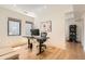 Bright home office featuring a sleek black desk, comfortable chair, and stylish decor, offering a productive space at 1717 Irving St, Denver, CO 80204