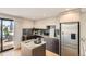 Modern kitchen with stainless steel appliances, stylish countertops, and direct access to the outdoor patio at 1717 Irving St, Denver, CO 80204