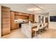 Stunning kitchen featuring custom wood cabinets, a marble island with seating, and stainless steel appliances at 1717 Irving St, Denver, CO 80204