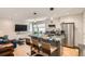 Open-concept kitchen with marble countertops, stainless steel appliances, and a breakfast bar at 1717 Irving St, Denver, CO 80204