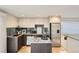 Well-lit modern kitchen featuring stainless steel appliances, granite countertops, and sleek cabinetry at 1717 Irving St, Denver, CO 80204