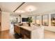 Open-concept kitchen showcasing a large marble island, custom cabinetry, and modern appliances at 1717 Irving St, Denver, CO 80204