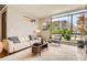Inviting living room featuring a modern sofa, comfortable seating, and a large window with natural light at 1717 Irving St, Denver, CO 80204