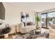 Cozy living room with a plush curved sofa, abstract art, and a view of the outdoor patio at 1717 Irving St, Denver, CO 80204