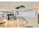 Bright, open-concept living space featuring modern design with a glass staircase and a view of the modern kitchen at 1717 Irving St, Denver, CO 80204