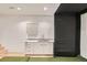 Recreation room featuring a golf simulator, wet bar, and carpeted floor for sports and activities at 1717 Irving St, Denver, CO 80204