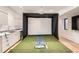 Spacious recreation room with a golf simulator, a wet bar, and plenty of space for entertainment at 1717 Irving St, Denver, CO 80204