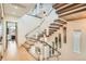 Modern staircase with wood treads, glass railing, stainless steel handrail and unique pendant lights at 1717 Irving St, Denver, CO 80204