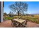 Outdoor patio features a stone tile floor with a table and seating, and an open grassy area in the backyard at 13686 Dexter St, Thornton, CO 80602