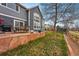 Home exterior features gray siding with a stone tile outdoor patio and grassy yard with a trampoline at 13686 Dexter St, Thornton, CO 80602