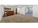 Open basement with wood-look floors, and a partially visible kitchen at 13686 Dexter St, Thornton, CO 80602