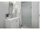 Bright bathroom featuring vanity with modern fixtures and a glass door shower at 13686 Dexter St, Thornton, CO 80602