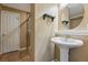Neutral toned bathroom with a large oval mirror and walk-in shower at 13686 Dexter St, Thornton, CO 80602