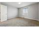 Carpeted bedroom offers a bright window and standard closet at 13686 Dexter St, Thornton, CO 80602