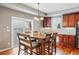 Elegant dining area featuring hardwood floors, modern lighting, and ample space for Gathering gatherings at 13686 Dexter St, Thornton, CO 80602