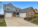 Spacious home boasts three-car garage and stone details for added curb appeal at 13686 Dexter St, Thornton, CO 80602