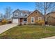 Charming two-story home boasts stone accents, solar panels, and a well-manicured front yard at 13686 Dexter St, Thornton, CO 80602