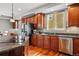 Kitchen featuring stainless steel appliances, granite countertops, hardwood floors, and a central island with cooktop at 13686 Dexter St, Thornton, CO 80602
