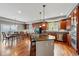 Spacious kitchen with a central island, stainless steel appliances, granite countertops, and hardwood flooring at 13686 Dexter St, Thornton, CO 80602