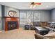 Inviting living room featuring a fireplace, plush seating, and ample natural light from large windows at 13686 Dexter St, Thornton, CO 80602