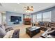 Spacious living room boasts a cozy fireplace, large TV, and comfortable seating for entertaining at 13686 Dexter St, Thornton, CO 80602