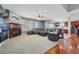 Open-concept living room featuring a cozy fireplace and seamless flow to the kitchen area at 13686 Dexter St, Thornton, CO 80602