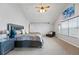 Bright main bedroom with carpet, vaulted ceiling, large windows, stylish décor, and a comfortable chaise lounge at 13686 Dexter St, Thornton, CO 80602
