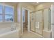 Relaxing bathroom featuring a soaking tub and glass shower at 10169 Briargrove Way, Highlands Ranch, CO 80126