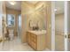 Well-lit bathroom featuring a single vanity, tiled floors, and a glass-enclosed shower at 10169 Briargrove Way, Highlands Ranch, CO 80126