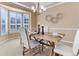 Charming dining room featuring a rustic wooden table, elegant white chairs, and natural lighting at 10169 Briargrove Way, Highlands Ranch, CO 80126