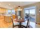 An eat-in kitchen boasts stainless steel appliances and a sliding door for easy deck access at 10169 Briargrove Way, Highlands Ranch, CO 80126