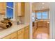 Bright kitchen features wood cabinets, stainless steel appliances, hardwood floors, and scenic outdoor views at 10169 Briargrove Way, Highlands Ranch, CO 80126