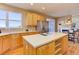 A kitchen has stainless steel appliances and connects to an eat-in nook with a fireplace at 10169 Briargrove Way, Highlands Ranch, CO 80126