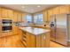 A spacious kitchen features stainless steel appliances, a kitchen island, and lots of natural light at 10169 Briargrove Way, Highlands Ranch, CO 80126