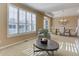 Inviting living room with plantation shutters, neutral decor, and view to dining area at 10169 Briargrove Way, Highlands Ranch, CO 80126
