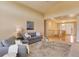 A vaulted ceiling and open staircase enhance the living room with access to the front entry at 10169 Briargrove Way, Highlands Ranch, CO 80126