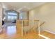 Bright living room with hardwood floors, a fireplace, vaulted ceiling, and view to the entry at 10169 Briargrove Way, Highlands Ranch, CO 80126