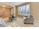 Cozy and inviting living room with staircase and plantation shutters, perfect for relaxation and entertainment at 10169 Briargrove Way, Highlands Ranch, CO 80126