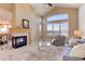 Vaulted ceilings and large windows illuminate the living room with a fireplace and neutral decor at 10169 Briargrove Way, Highlands Ranch, CO 80126