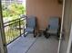 Outdoor balcony with two comfortable chairs and a small table, perfect for relaxing outdoors at 2700 E Cherry Creek S Dr # 302, Denver, CO 80209