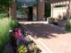 Brick walkway entrance to the building displays colorful flower beds and sitting bench at 2700 E Cherry Creek S Dr # 302, Denver, CO 80209