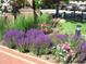 Brick trimmed flowerbeds around the complex contain colorful flowers and lush greenery at 2700 E Cherry Creek S Dr # 302, Denver, CO 80209