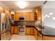 Oak kitchen cabinets, granite countertops and stainless appliances create a modern feel at 2700 E Cherry Creek S Dr # 302, Denver, CO 80209