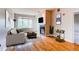 Cozy living room featuring hardwood floors, a fireplace, a sofa and a bar cart at 2700 E Cherry Creek S Dr # 302, Denver, CO 80209